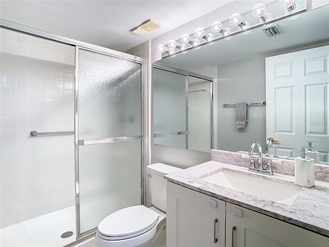 full bath with a stall shower, visible vents, and vanity