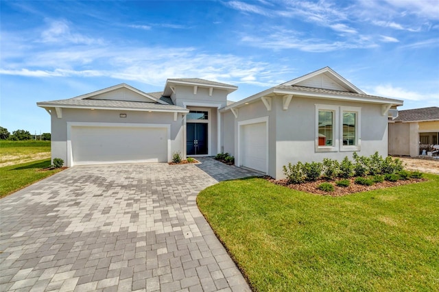 10714 Torchwood Sea Way, San Antonio, FL 33576 - view of front of home featuring a garage, a front lawn, decorative driveway, and stucco siding