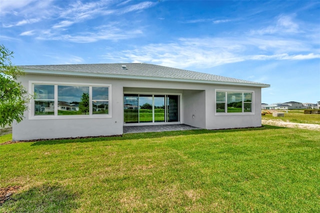 10714 Torchwood Sea Way, San Antonio, FL 33576 - rear view of house featuring stucco siding, a patio area, and a yard