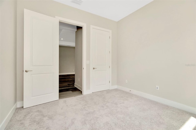 10714 Torchwood Sea Way, San Antonio, FL 33576 - unfurnished bedroom featuring light carpet, visible vents, and baseboards