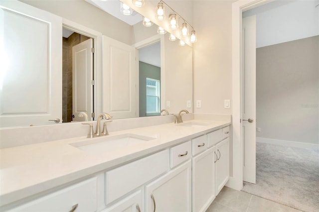 10714 Torchwood Sea Way, San Antonio, FL 33576 - bathroom featuring double vanity, tile patterned flooring, baseboards, and a sink