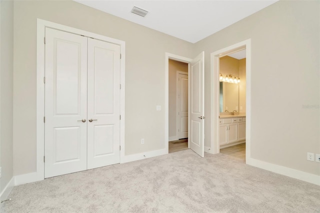 10714 Torchwood Sea Way, San Antonio, FL 33576 - unfurnished bedroom with baseboards, a closet, visible vents, and light colored carpet