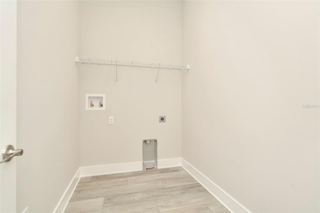 10714 Torchwood Sea Way, San Antonio, FL 33576 - laundry room featuring laundry area, baseboards, hookup for a washing machine, light wood-type flooring, and electric dryer hookup