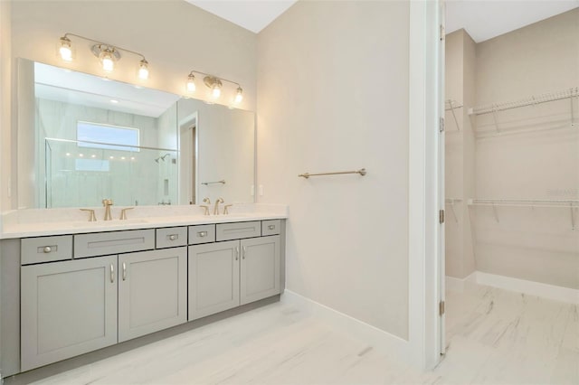 10714 Torchwood Sea Way, San Antonio, FL 33576 - bathroom with double vanity, a stall shower, baseboards, and a sink