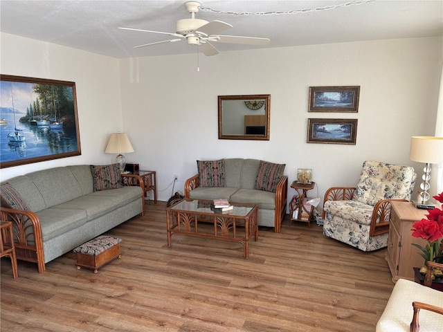 living room featuring ceiling fan and wood finished floors