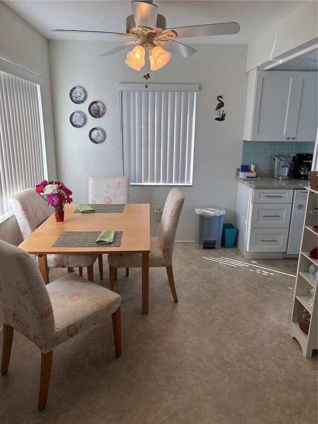 dining room with light carpet and ceiling fan