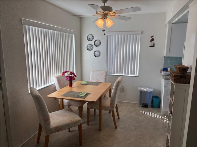 dining room with ceiling fan and baseboards