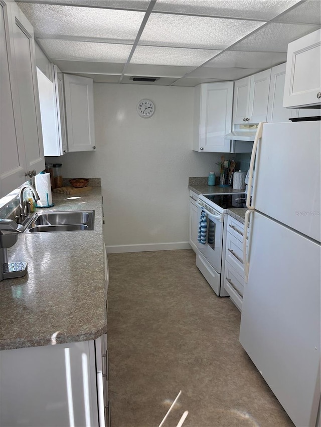 kitchen featuring a paneled ceiling, white cabinets, a sink, white appliances, and under cabinet range hood