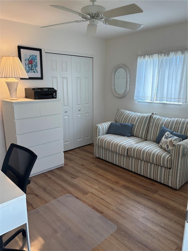 living area featuring ceiling fan and wood finished floors