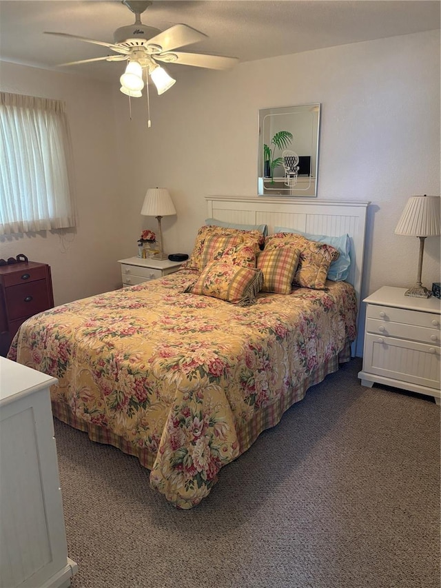 bedroom with ceiling fan and dark carpet