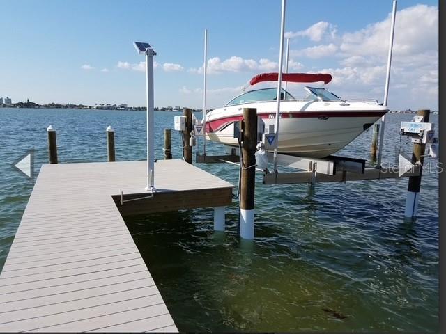 view of dock featuring a water view and boat lift