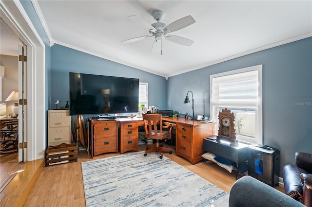 home office with light wood finished floors, ceiling fan, ornamental molding, and vaulted ceiling