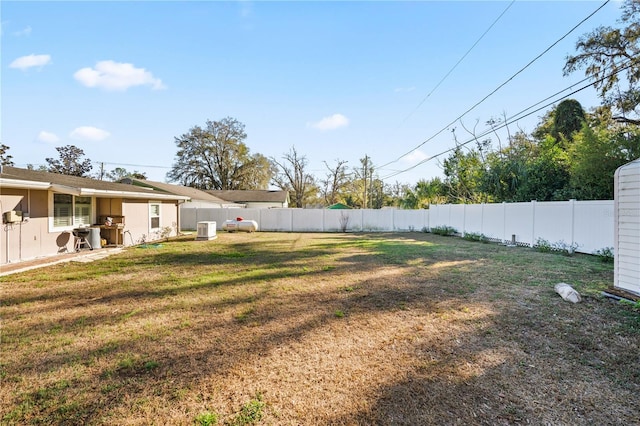 view of yard with a fenced backyard and cooling unit