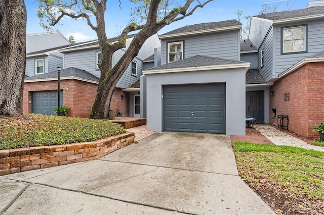 traditional-style home with concrete driveway and an attached garage