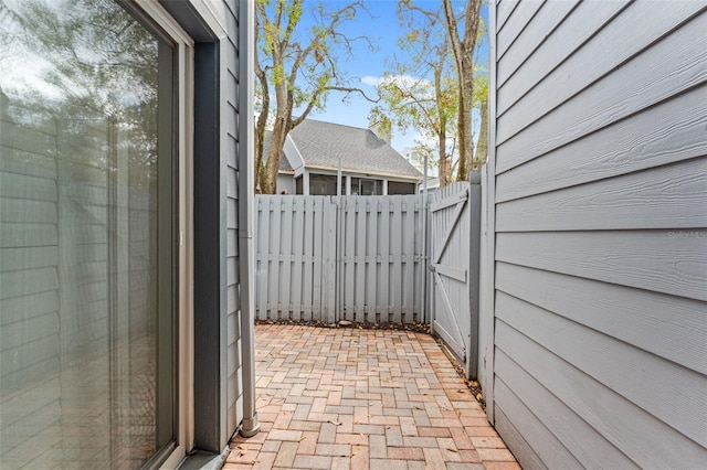 view of patio with a gate and fence