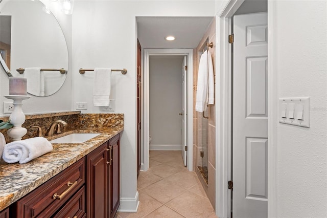 full bath featuring toilet, baseboards, vanity, and tile patterned floors