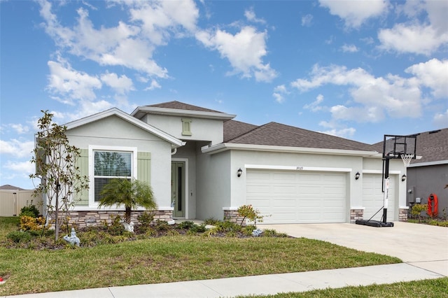 view of front of home featuring concrete driveway, stucco siding, an attached garage, and a front yard