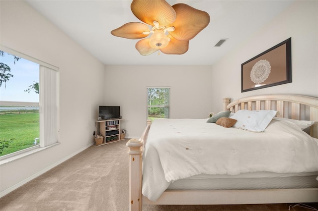 bedroom featuring visible vents, ceiling fan, light carpet, and baseboards