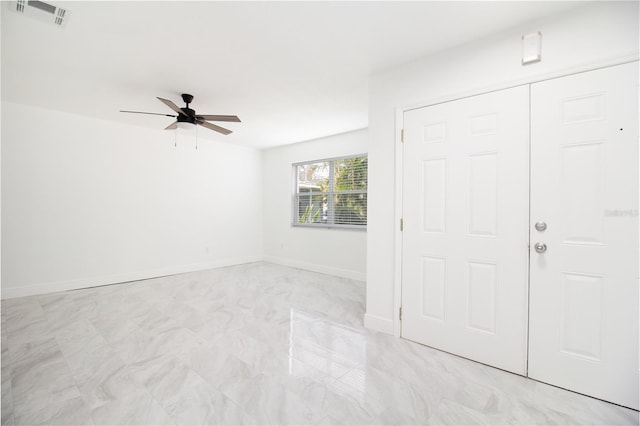 foyer with baseboards, visible vents, and a ceiling fan