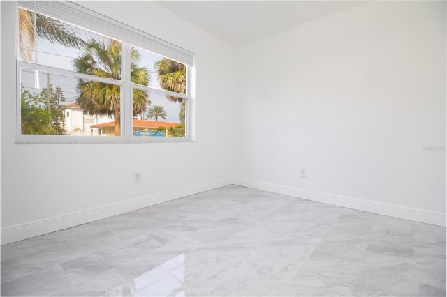 empty room with marble finish floor and baseboards