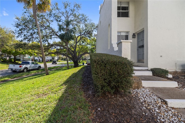 view of home's exterior featuring a lawn and stucco siding