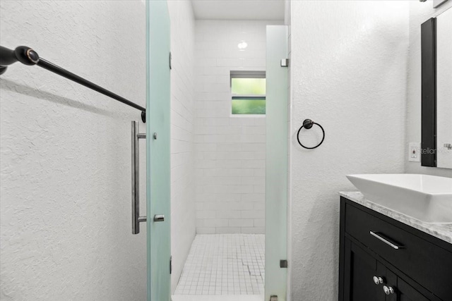 4440 58th Ave N, Saint Petersburg, FL 33714 - bathroom with a textured wall, a shower stall, and vanity