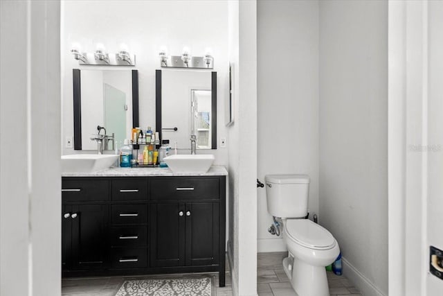 4440 58th Ave N, Saint Petersburg, FL 33714 - full bath featuring double vanity, a sink, toilet, and baseboards