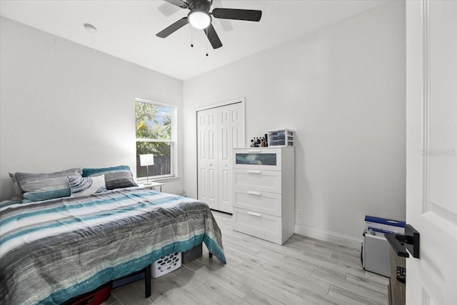 4440 58th Ave N, Saint Petersburg, FL 33714 - bedroom with light wood finished floors, ceiling fan, baseboards, and a closet