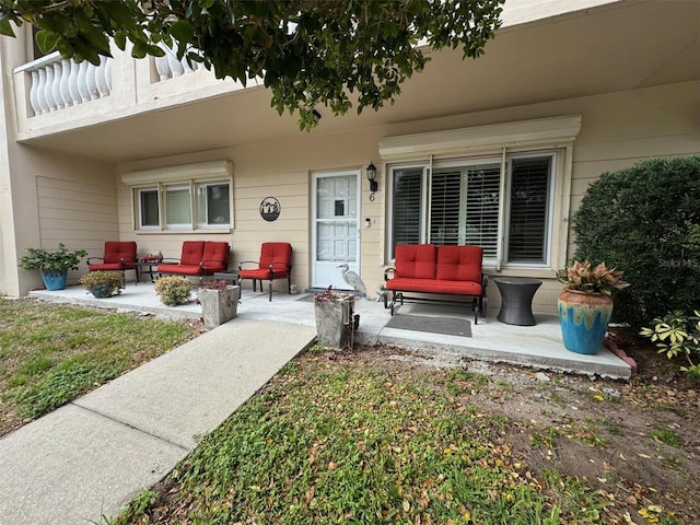 view of exterior entry with outdoor lounge area and a patio area