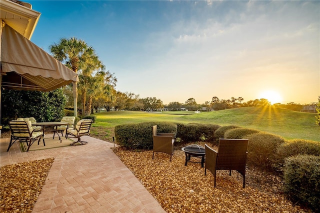 surrounding community featuring a patio area, a yard, and a fire pit