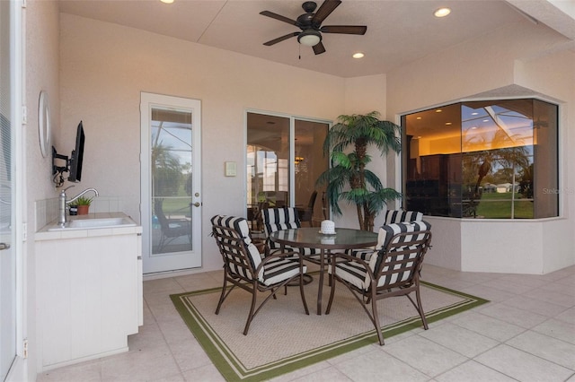 view of patio featuring an outdoor bar, a sink, and a ceiling fan