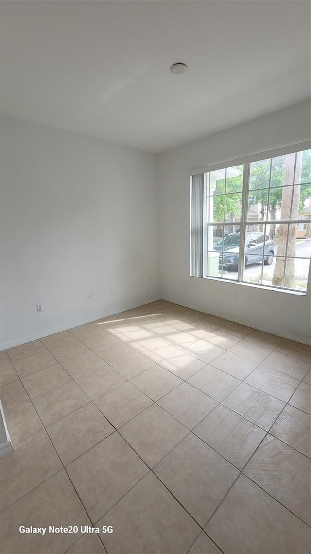 empty room with light tile patterned flooring