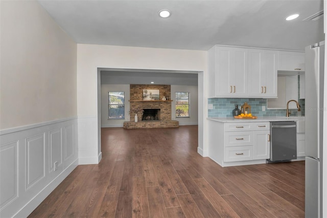 kitchen featuring white cabinetry, dark wood-style flooring, freestanding refrigerator, light countertops, and dishwasher