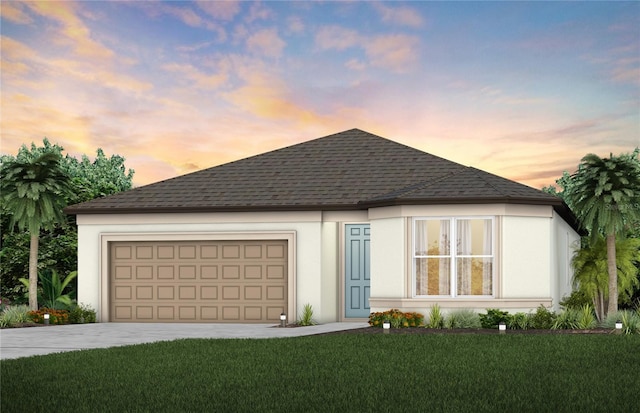 ranch-style house featuring stucco siding, a lawn, roof with shingles, and a garage
