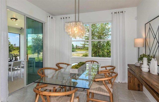 tiled dining room featuring a notable chandelier