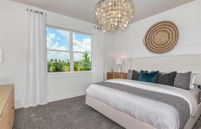 carpeted bedroom with baseboards and a chandelier