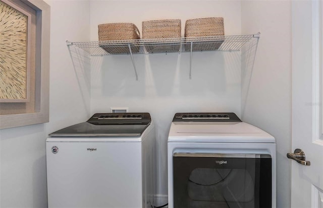 washroom with washing machine and dryer and laundry area