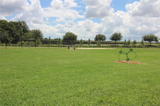 view of yard featuring a rural view and fence