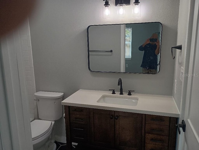 full bathroom featuring vanity and toilet