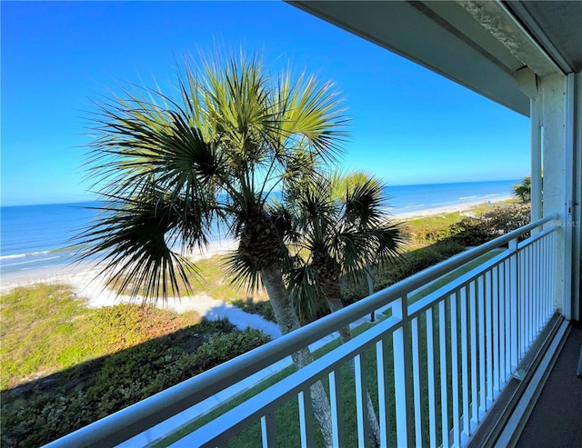 balcony with a water view and a beach view