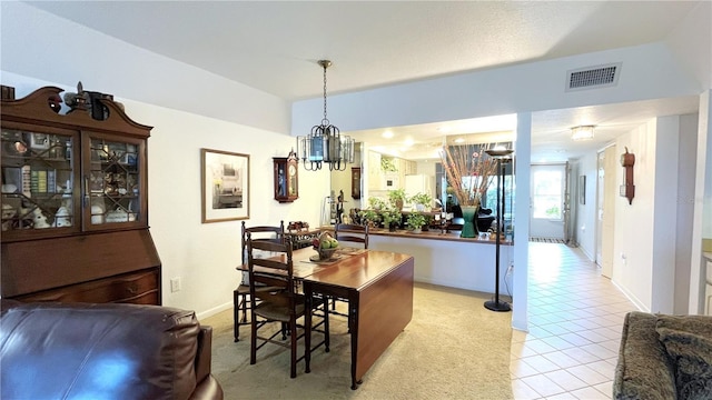 dining space with light tile patterned floors, baseboards, and visible vents