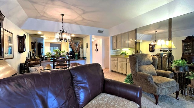 living area featuring a chandelier, light tile patterned floors, and visible vents