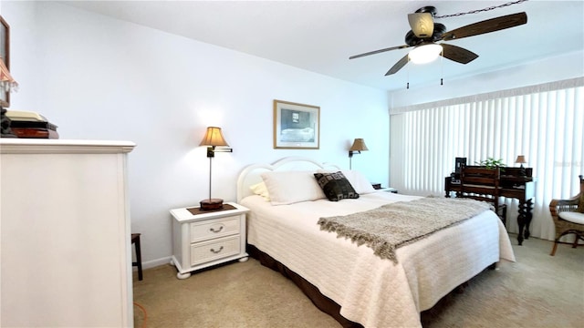 bedroom featuring light carpet and ceiling fan