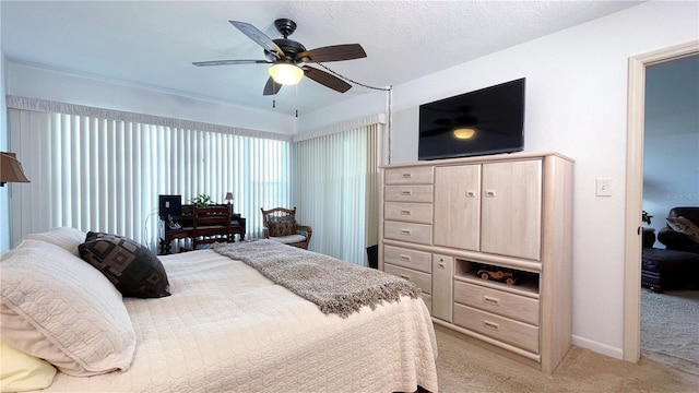 bedroom with baseboards, a ceiling fan, and light colored carpet