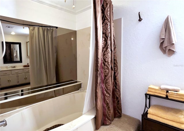 bathroom featuring visible vents, shower / bath combo, ornamental molding, and vanity