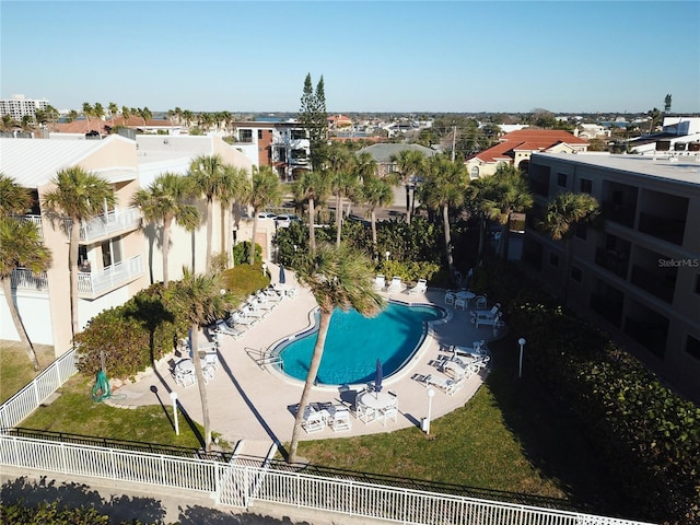 pool featuring a patio area, fence, and a residential view