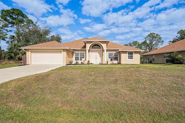 mediterranean / spanish house featuring a garage, driveway, a front yard, and stucco siding