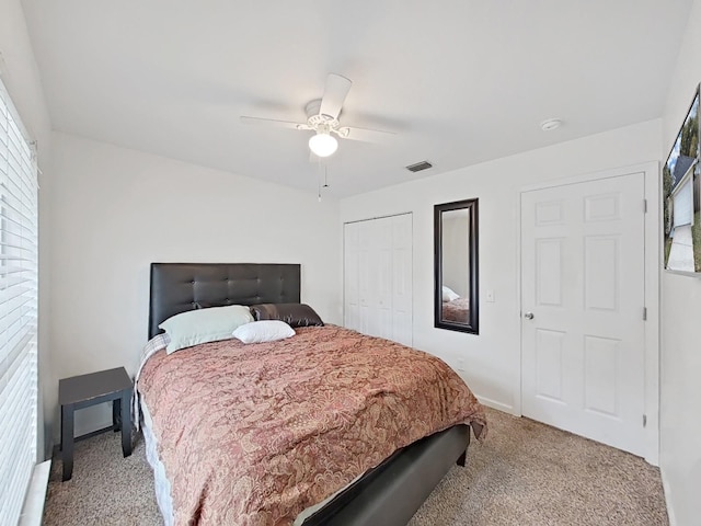 bedroom with light colored carpet, visible vents, baseboards, a ceiling fan, and a closet