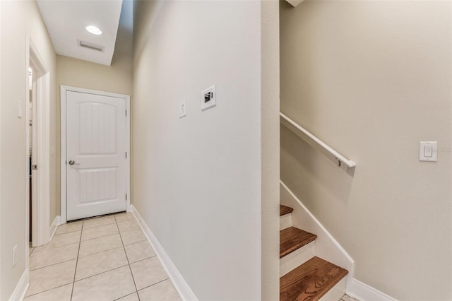 staircase with tile patterned flooring, visible vents, and baseboards