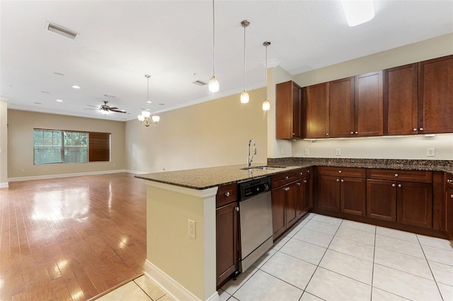 kitchen featuring pendant lighting, stainless steel dishwasher, open floor plan, dark stone counters, and a peninsula